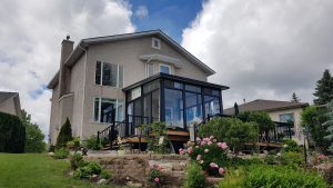Black studio standing out in a landscaped backyard