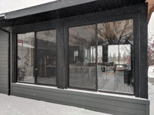 black curtain walls adds wow to this grey home